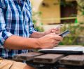 handsome-man-relaxing-his-garden-using-laptop-shop-sunny-day