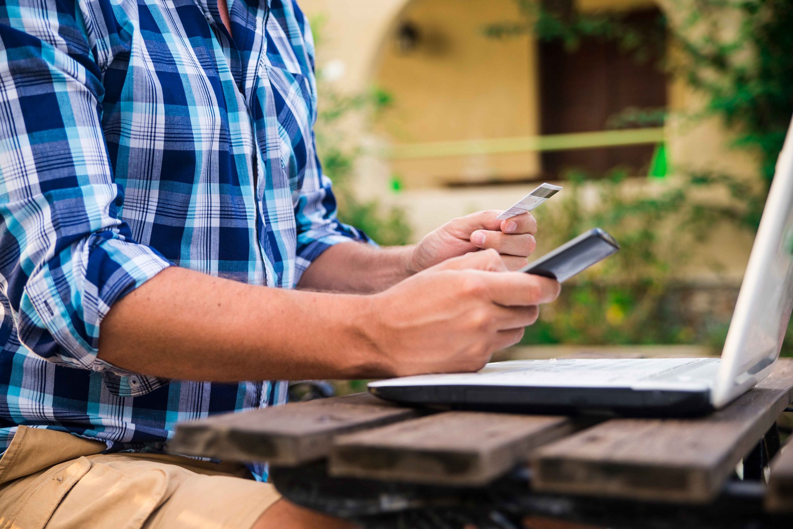 handsome-man-relaxing-his-garden-using-laptop-shop-sunny-day